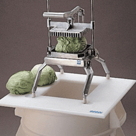 Commercial Easy LettuceKutter positioned over a collection receptacle, shredding whole heads of lettuce directly into the container below.